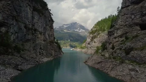 Drone moving forward between the rocks near to the lake Stock Footage 155759797