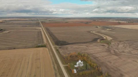 Drone moving forward high above a prairie setting of autumn tilled fields Stock Footage 142318613