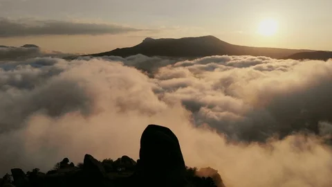Drone moving forward in the orange sky through the fluffy clouds in the evening Stock Footage 123173512