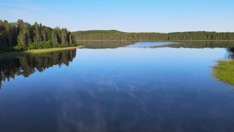 Drone moving forward over a very calm lake that has a thin mist.  Stock Footage 246946383
