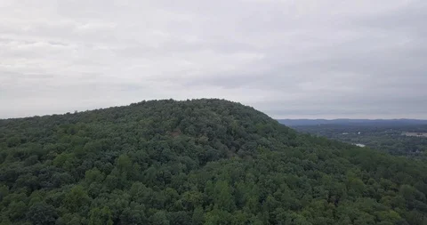 Drone moving forward towards forest hilltop Stock-Footage 95611751
