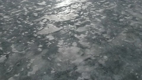 Drone moving forwards and looking down at a frozen lake  Stock Footage 151764643