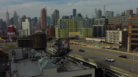 Drone moving L - R over Highway, New York City &amp; Long Island City background Stock Footage 145426839