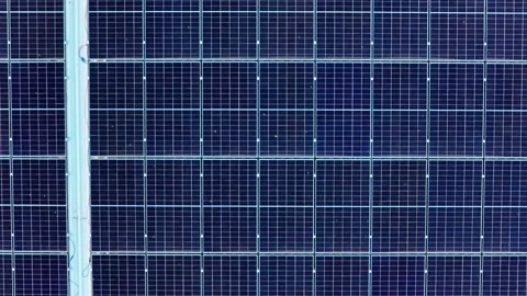Drone moving left above solar power field on industrial building, showing g.. Video stock 320951198