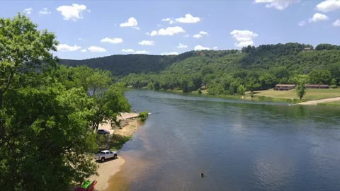 Drone moving up looking over a running river with trout fishing Stockbeeldmateriaal 200981816