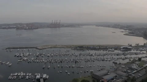 Drone moving over moored yachts to Durban harbour. Video stock 239381607