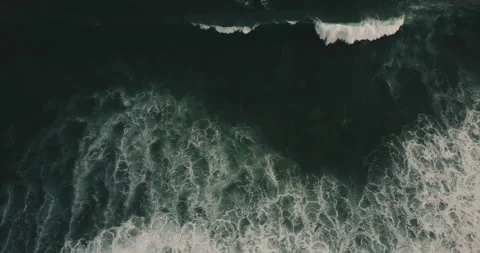 Drone moving right over huge wild dark blue open ocean waves crashing down Stock Footage 90567191
