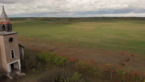 Drone moving sideways featuring a large, abandoned church in a rural setting. Stock Footage 139872809
