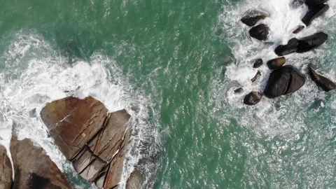 Drone moving sideways over a rocky beach Stock Footage 194446111