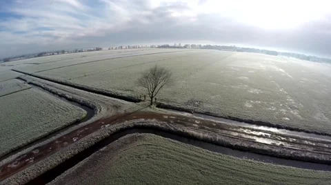 Drone moving slowly backwards sideways along rural dirt road during winter 4k Stock Footage 61032200