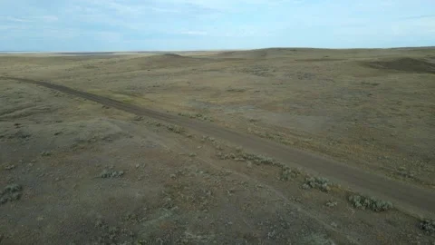 Drone moving slowly forward low above a dry barren western landscape  Stock Footage 255670125