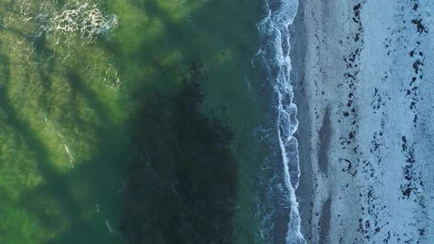 Drone moving slowly forwards over desolate beach on a winter morning Stock Footage 287915763