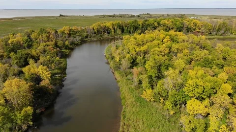 Drone moving slowly forwards to show a vast farm, forest and river landscape Stock Footage 117859247