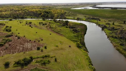Drone moving slowly forwards to show a vast farm, forest and river landscape Stock Footage 117859280