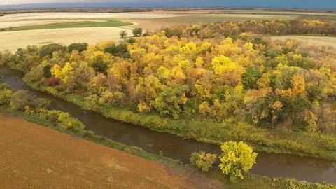 Drone moving slowly forwards to show a vast farm, forest and river and landscape Stock Footage 118153015