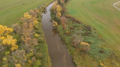 Drone moving slowly forwards to show a vast farm, forest and river and landscape Stock Footage 118153160