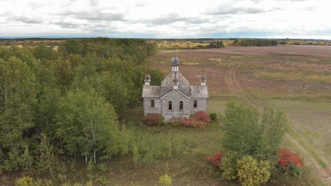 Drone moving slowly over an abandoned and dilapidated white church Stock Footage 116838018
