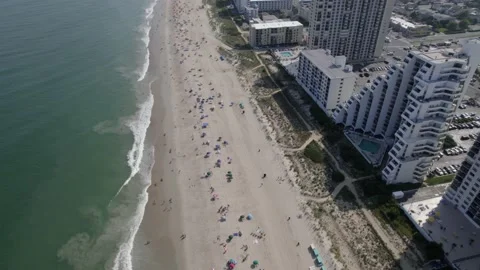 Drone moving slowly over Ocean City MD shoreline Stock Footage 160072324