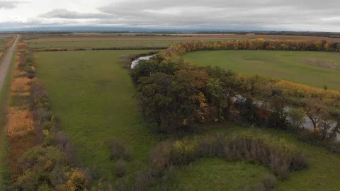 Drone moving slowly over a vast area of farm fields with large meadows Stock Footage 117697234
