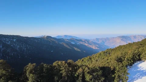 Drone moving to the thick vegetation on mountain slope from the snow ground.  Stock Footage 158071148