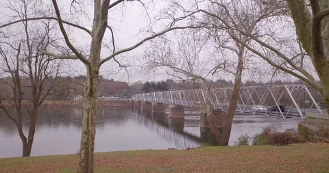 Drone moving through trees to bridge winter Stock Footage 98840593