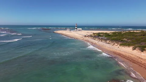 Drone Moving Toward Distant Lighthouse with View of Sea, Waves, Coastline, Coast Stock Footage 306356396