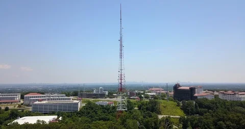 Drone moving towards large red and white radio tower Stockbeeldmateriaal 112140311