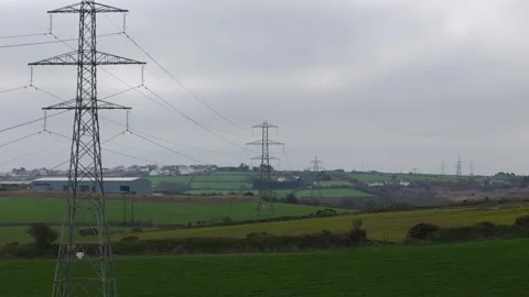 Drone Moving Towards Power Grid Pilons With Electricity Wires In UK Countryside Stock Footage 301092830
