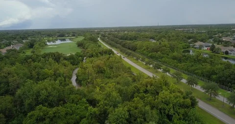 Drone moving from trees to road in florida Stock Footage 94827565