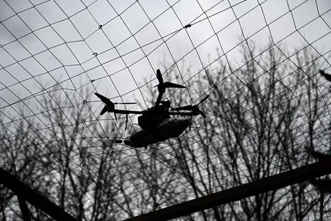 Drone with munitions got caught behind the anti-drone net Stock Photos