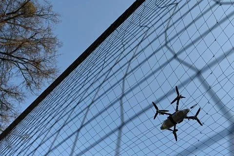Drone with munitions got caught behind the anti-drone net Stock Photos