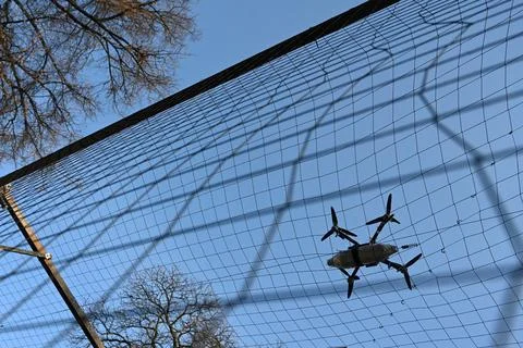 Drone with munitions got caught behind the anti-drone net Stock Photos