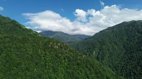 Drone near three forested peaks, cloud over summit, Adjara 스톡 동영상 337340231