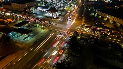 Drone night hyperlapse of busy intersection with pan up Stock Footage 86576700