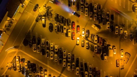 Drone night hyperlapse of busy parking lot at night as camera turns Stock Footage 87903597