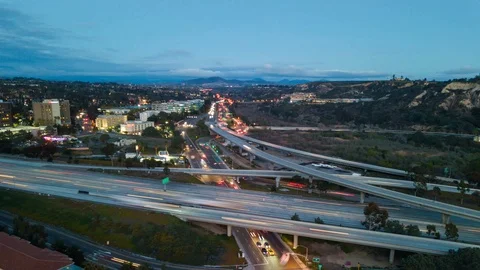 Drone night hyperlapse of intersection of 2 California freeways with cam pandown Stock Footage 86620312