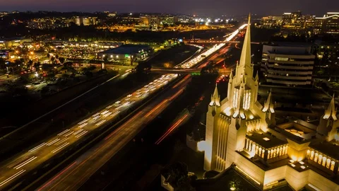 Drone nightlapse shows busy freeway, shopping plaza, and Mormon Temple Stock Footage 85643571