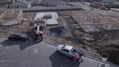 A drone observes an extendable forklift in action, gently lowering the Stock Footage 255815227