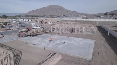 A drone observes an extendable forklift (telehandler) gently lowering a Stock Footage 255815597