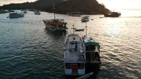 Drone, ocean sunset with boats floating on the water, Indonesia Stock Footage 131436802