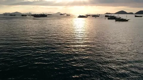 Drone, ocean sunset, cloudy orange sky, boat silhouettes, Indonesia Stock Footage 131436920