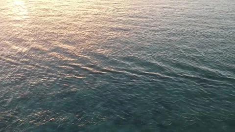 Drone, ocean sunset, golden reflections on the water, island and boat silhou Video stock 131436957