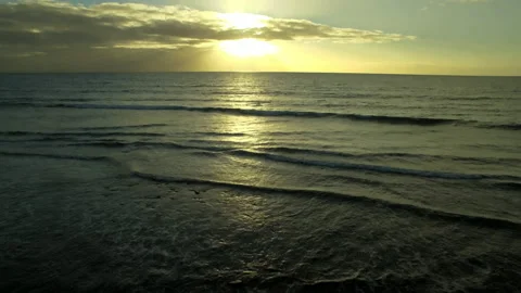 Drone ocean waves with sunset 4k Stock Footage 143689876