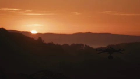 Drone octocopter filming dramatic bright orange and pink sunset Stock Footage 91376245