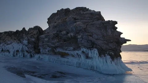 Drone Ogoy sunset Island Sharp rock splashes blue ice cracks lake Baikal Winter Stock Footage 88167938