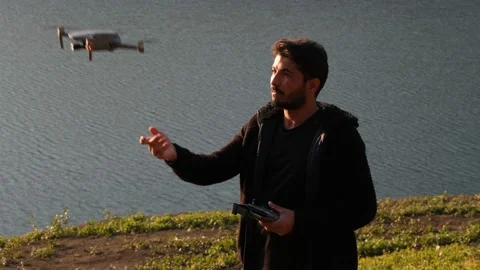 Drone operator, drone operator airing drone with hand in close-up Stock Footage 166419693