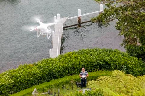 Drone Operator flying a drone - seen from above Stock Photos
