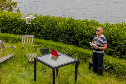 Drone Operator flying a drone - seen from the side Stock Photos
