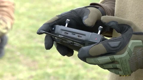 The drone operator holds a joystick in his hands and controls the drone Stock-Footage 223092335