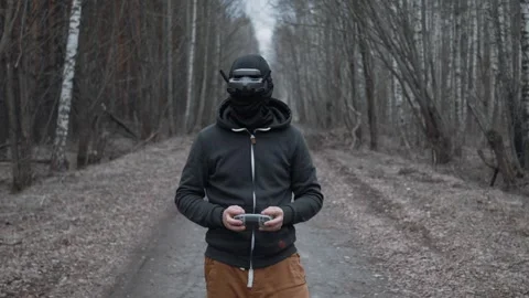 A drone operator prepares to take off in the forest Stock Footage 305322288